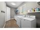Clean laundry room, washer, dryer, and storage at 2329 Pinellas Dr, Punta Gorda, FL 33983