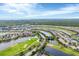 Beautiful aerial view of a Primary-planned community with golf course, water features, and manicured landscaping at 25187 Keygrass Ct, Punta Gorda, FL 33955