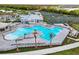 Aerial view of the community pool, clubhouse, and tennis courts at 25187 Keygrass Ct, Punta Gorda, FL 33955