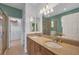Bathroom featuring dual sinks, granite counters, and a glass-enclosed shower at 25187 Keygrass Ct, Punta Gorda, FL 33955