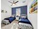 Cozy bedroom featuring two twin beds, a central nightstand, and beach themed decor at 25187 Keygrass Ct, Punta Gorda, FL 33955
