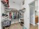 Walk-in closet with shelving, and storage for clothes, shoes, and accessories, leading to the bathroom at 25187 Keygrass Ct, Punta Gorda, FL 33955