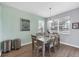Inviting dining room with a contemporary table, chairs, and natural light from the large window at 25187 Keygrass Ct, Punta Gorda, FL 33955
