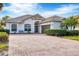 Beautiful home featuring tile roof, well-maintained landscaping, and brick driveway at 25187 Keygrass Ct, Punta Gorda, FL 33955