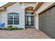Close-up of front entrance with decorative glass door and brick-paved walkway at 25187 Keygrass Ct, Punta Gorda, FL 33955