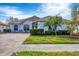 Well-maintained home with a brick driveway, lush green lawn, and manicured shrubs at 25187 Keygrass Ct, Punta Gorda, FL 33955