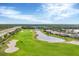 Scenic view of the golf course featuring pristine greens and surrounding nature at 25187 Keygrass Ct, Punta Gorda, FL 33955