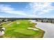 Scenic view of the lush green golf course featuring pristine greens and surrounding lakes at 25187 Keygrass Ct, Punta Gorda, FL 33955