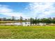 Beautiful backyard pond view with well-maintained grass at 25187 Keygrass Ct, Punta Gorda, FL 33955