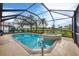 Screened in pool and attached spa with manicured shrubs overlooking pond at 25187 Keygrass Ct, Punta Gorda, FL 33955