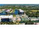 Aerial view showcasing Emerald Pointe's waterfront location, tennis courts, and multiple buildings at 25188 Marion Ave # D205, Punta Gorda, FL 33950