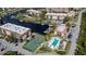 Aerial view of Emerald Pointe community, featuring tennis courts, pool, and waterfront access at 25188 Marion Ave # D205, Punta Gorda, FL 33950