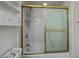 Clean bathroom with shower/tub combo and gold accents at 25188 Marion Ave # D205, Punta Gorda, FL 33950