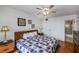 King-size bed, ceiling fan, and hardwood floors at 25188 Marion Ave # D205, Punta Gorda, FL 33950