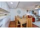Dining area with light wood table and chairs near kitchen at 25188 Marion Ave # D205, Punta Gorda, FL 33950