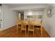 Dining area with light wood table and chairs near kitchen at 25188 Marion Ave # D205, Punta Gorda, FL 33950