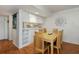 Dining area with light wood table and chairs near kitchen at 25188 Marion Ave # D205, Punta Gorda, FL 33950