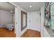 Bright entryway with hardwood floors and mirror at 25188 Marion Ave # D205, Punta Gorda, FL 33950