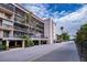 Condo building exterior showcasing parking and landscaping at 25188 Marion Ave # D205, Punta Gorda, FL 33950