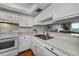 White kitchen with stainless steel sink and appliances at 25188 Marion Ave # D205, Punta Gorda, FL 33950