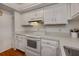 Kitchen with white cabinets, electric range, and light countertops at 25188 Marion Ave # D205, Punta Gorda, FL 33950