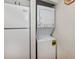 Stackable white washer and dryer in kitchen at 25188 Marion Ave # D205, Punta Gorda, FL 33950