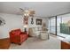 Bright living room featuring comfortable seating and balcony access at 25188 Marion Ave # D205, Punta Gorda, FL 33950