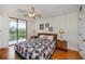Main bedroom with sliding door to balcony at 25188 Marion Ave # D205, Punta Gorda, FL 33950