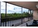 Relaxing screened balcony overlooking lush greenery and a road at 25188 Marion Ave # D205, Punta Gorda, FL 33950
