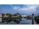 Serene waterfront view with boat docks and community buildings reflecting in the water at 25188 Marion Ave # D205, Punta Gorda, FL 33950