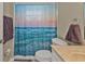 Guest bathroom with ocean-themed shower curtain at 2577 Mauritania Rd, Punta Gorda, FL 33983