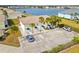 An aerial view of a yellow building, parking lot, and lake at 26346 Rampart Blvd # 904, Punta Gorda, FL 33983
