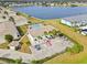 Aerial view showcasing a yellow building near a pool and lake at 26346 Rampart Blvd # 904, Punta Gorda, FL 33983