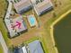 Aerial view of a yellow building near a pool and lake at 26346 Rampart Blvd # 904, Punta Gorda, FL 33983