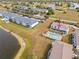 An aerial view of a community with a yellow building near a lake at 26346 Rampart Blvd # 904, Punta Gorda, FL 33983