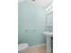 Small bathroom with pedestal sink and light teal walls at 26346 Rampart Blvd # 904, Punta Gorda, FL 33983
