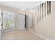View of entryway with white door and staircase at 26346 Rampart Blvd # 904, Punta Gorda, FL 33983