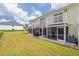 Back exterior showing screened patios and lawn at 26346 Rampart Blvd # 904, Punta Gorda, FL 33983