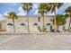 Ground level view of a yellow building with parking spaces in front at 26346 Rampart Blvd # 904, Punta Gorda, FL 33983