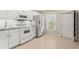 White kitchen with stainless steel appliances and subway tile backsplash at 26346 Rampart Blvd # 904, Punta Gorda, FL 33983