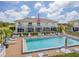A yellow building with a pool and patio furniture at 26346 Rampart Blvd # 904, Punta Gorda, FL 33983