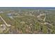 Aerial view showcasing home, waterway, and surrounding landscape at 3000 Narcissus Ter, North Port, FL 34286