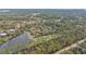 Aerial view of a secluded property with a pond and lush vegetation at 3000 Narcissus Ter, North Port, FL 34286