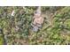 Aerial view of home with pool and surrounding trees at 3000 Narcissus Ter, North Port, FL 34286