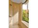 Walk-in shower with window overlooking garden at 3000 Narcissus Ter, North Port, FL 34286