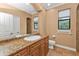 Bathroom with granite countertop, single sink and toilet at 3000 Narcissus Ter, North Port, FL 34286