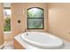Oval soaking tub and walk-in shower with pebble floor at 3000 Narcissus Ter, North Port, FL 34286