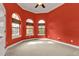 Bright bedroom with red walls, carpet flooring, and multiple windows at 3000 Narcissus Ter, North Port, FL 34286