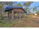 Rustic wooden chicken coop in backyard setting at 3000 Narcissus Ter, North Port, FL 34286