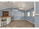 Tiled dining area with a chandelier and bar at 3000 Narcissus Ter, North Port, FL 34286